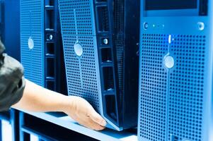 IT engineer repairing a server in a datacenter photo