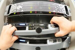 IT engineer repairing a server in a datacenter photo