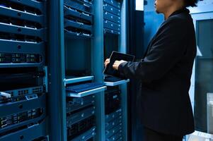 IT engineer repairing a server in a datacenter photo