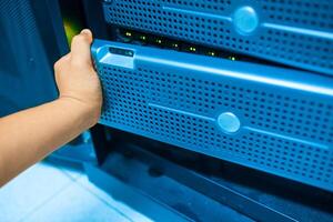 IT engineer repairing a server in a datacenter photo