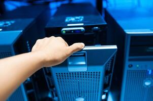 IT engineer repairing a server in a datacenter photo