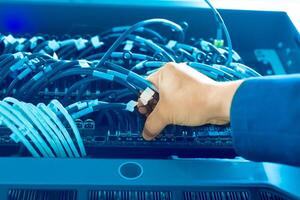 IT engineer repairing a server in a datacenter photo