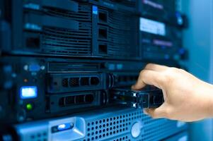 IT engineer repairing a server in a datacenter photo