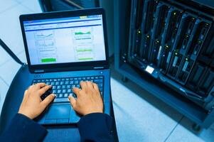 IT engineer repairing a server in a datacenter photo