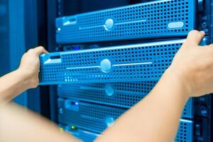 IT engineer repairing a server in a datacenter photo