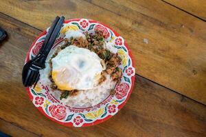 Pork Basil with Egg on table with soft light . photo