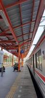 Activity people at railway train station Bekasi. Local train Indonesia. Railway road. West Java, Indonesia - April 8 2024 photo