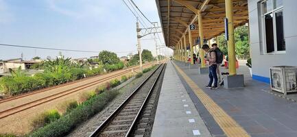 Activity people at railway train station Bekasi. Local train Indonesia. Railway road. West Java, Indonesia - April 8 2024 photo