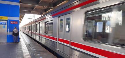 Activity people at railway train station Bekasi. Local train Indonesia. Railway road. West Java, Indonesia - April 8 2024 photo