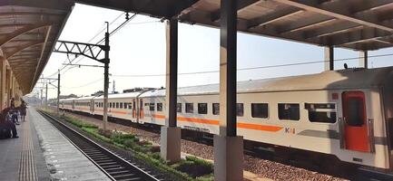 Activity people at railway train station Bekasi. Local train Indonesia. Railway road. West Java, Indonesia - April 8 2024 photo