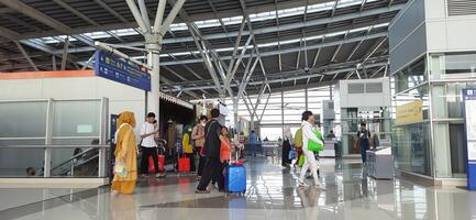 The atmosphere travelers or mudik lebaran or pulang kampung or idul fitri moments in train station Bekasi. West Java, Indonesia - April 8 2024 photo
