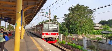 Activity people at railway train station Bekasi. Local train Indonesia. Railway road. West Java, Indonesia - April 8 2024 photo