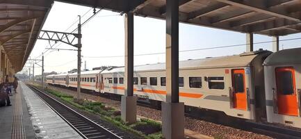 Activity people at railway train station Bekasi. Local train Indonesia. Railway road. West Java, Indonesia - April 8 2024 photo