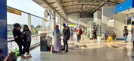 Activity people at railway train station Bekasi. Local train Indonesia. Railway road. West Java, Indonesia - April 8 2024 photo