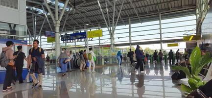 The atmosphere travelers or mudik lebaran or pulang kampung or idul fitri moments in train station Bekasi. West Java, Indonesia - April 8 2024 photo