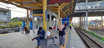 Activity people at railway train station Bekasi. Local train Indonesia. Railway road. West Java, Indonesia - April 8 2024 photo