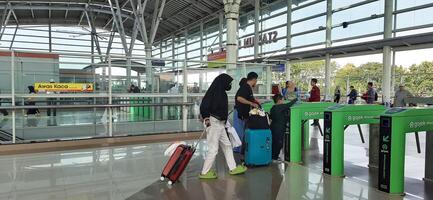 The atmosphere travelers or mudik lebaran or pulang kampung or idul fitri moments in train station Bekasi. West Java, Indonesia - April 8 2024 photo