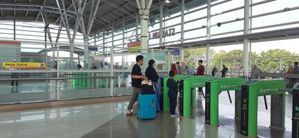 The atmosphere travelers or mudik lebaran or pulang kampung or idul fitri moments in train station Bekasi. West Java, Indonesia - April 8 2024 photo