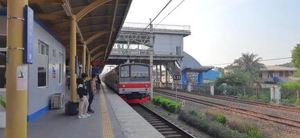 Activity people at railway train station Bekasi. Local train Indonesia. Railway road. West Java, Indonesia - April 8 2024 photo