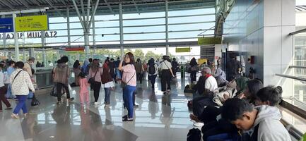 The atmosphere travelers or mudik lebaran or pulang kampung or idul fitri moments in train station Bekasi. West Java, Indonesia - April 8 2024 photo