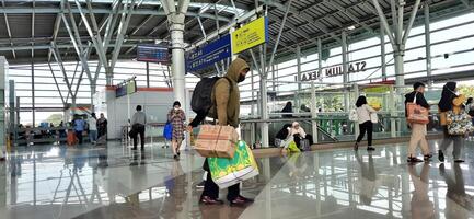 The atmosphere travelers or mudik lebaran or pulang kampung or idul fitri moments in train station Bekasi. West Java, Indonesia - April 8 2024 photo