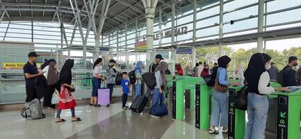 The atmosphere travelers or mudik lebaran or pulang kampung or idul fitri moments in train station Bekasi. West Java, Indonesia - April 8 2024 photo