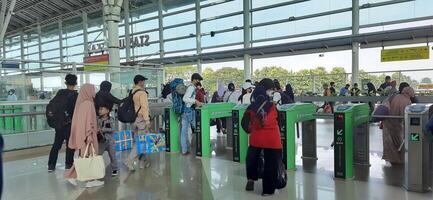 The atmosphere travelers or mudik lebaran or pulang kampung or idul fitri moments in train station Bekasi. West Java, Indonesia - April 8 2024 photo