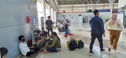 The atmosphere travelers or mudik lebaran or pulang kampung or idul fitri moments in train station Bekasi. West Java, Indonesia - April 8 2024 photo