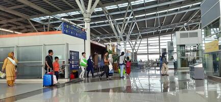 The atmosphere travelers or mudik lebaran or pulang kampung or idul fitri moments in train station Bekasi. West Java, Indonesia - April 8 2024 photo