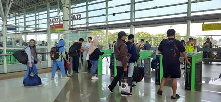 The atmosphere travelers or mudik lebaran or pulang kampung or idul fitri moments in train station Bekasi. West Java, Indonesia - April 8 2024 photo
