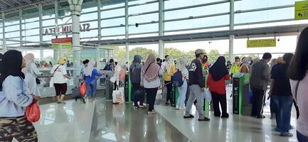 The atmosphere travelers or mudik lebaran or pulang kampung or idul fitri moments in train station Bekasi. West Java, Indonesia - April 8 2024 photo