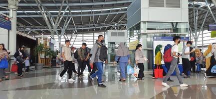 The atmosphere travelers or mudik lebaran or pulang kampung or idul fitri moments in train station Bekasi. West Java, Indonesia - April 8 2024 photo