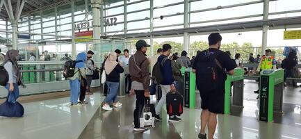 The atmosphere travelers or mudik lebaran or pulang kampung or idul fitri moments in train station Bekasi. West Java, Indonesia - April 8 2024 photo