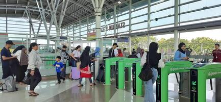 The atmosphere travelers or mudik lebaran or pulang kampung or idul fitri moments in train station Bekasi. West Java, Indonesia - April 8 2024 photo