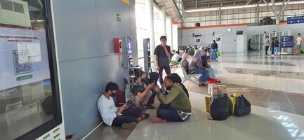 The atmosphere travelers or mudik lebaran or pulang kampung or idul fitri moments in train station Bekasi. West Java, Indonesia - April 8 2024 photo