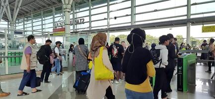 The atmosphere travelers or mudik lebaran or pulang kampung or idul fitri moments in train station Bekasi. West Java, Indonesia - April 8 2024 photo