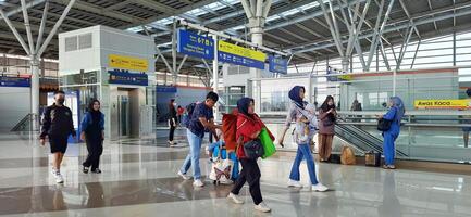 The atmosphere travelers or mudik lebaran or pulang kampung or idul fitri moments in train station Bekasi. West Java, Indonesia - April 8 2024 photo