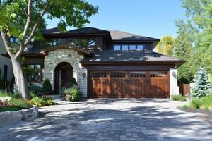 Garage door with a driveway in front. photo