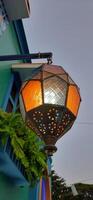 Beautiful Arabian Turkish hanging light. Lantern lamp night decoration exterior background photo