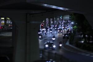 un noche miniatura tráfico mermelada a el urbano calle en tokio foto