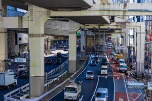 A traffic jam at the city street under the highway in Tokyo photo