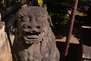 A guardian statue at Tomioka Shrine with copyspace photo