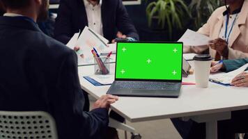 Business partners attending meeting next to greenscreen laptop, discussing the fate of the global enterprise and working on developing financial resources. Startup team address daily issues. Camera A. video