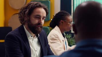Team of associates working on resource allocation plans during a meeting, making important budgeting and staffing decisions to corelate with company objectives. Employees review strategies. Camera A. video