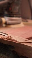 Vertical Craftsperson carving into wood using chisel and hammer in carpentry shop with precision. Manufacturer in studio shaping wooden pieces with tools, making wood art, camera A close up shot video