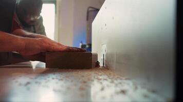 CNC machinist operating spindle moulder to create bespoke joinery for client commissioned project. Carpenter performing tasks on wood shaper, shaping and cutting materials, camera B close up video