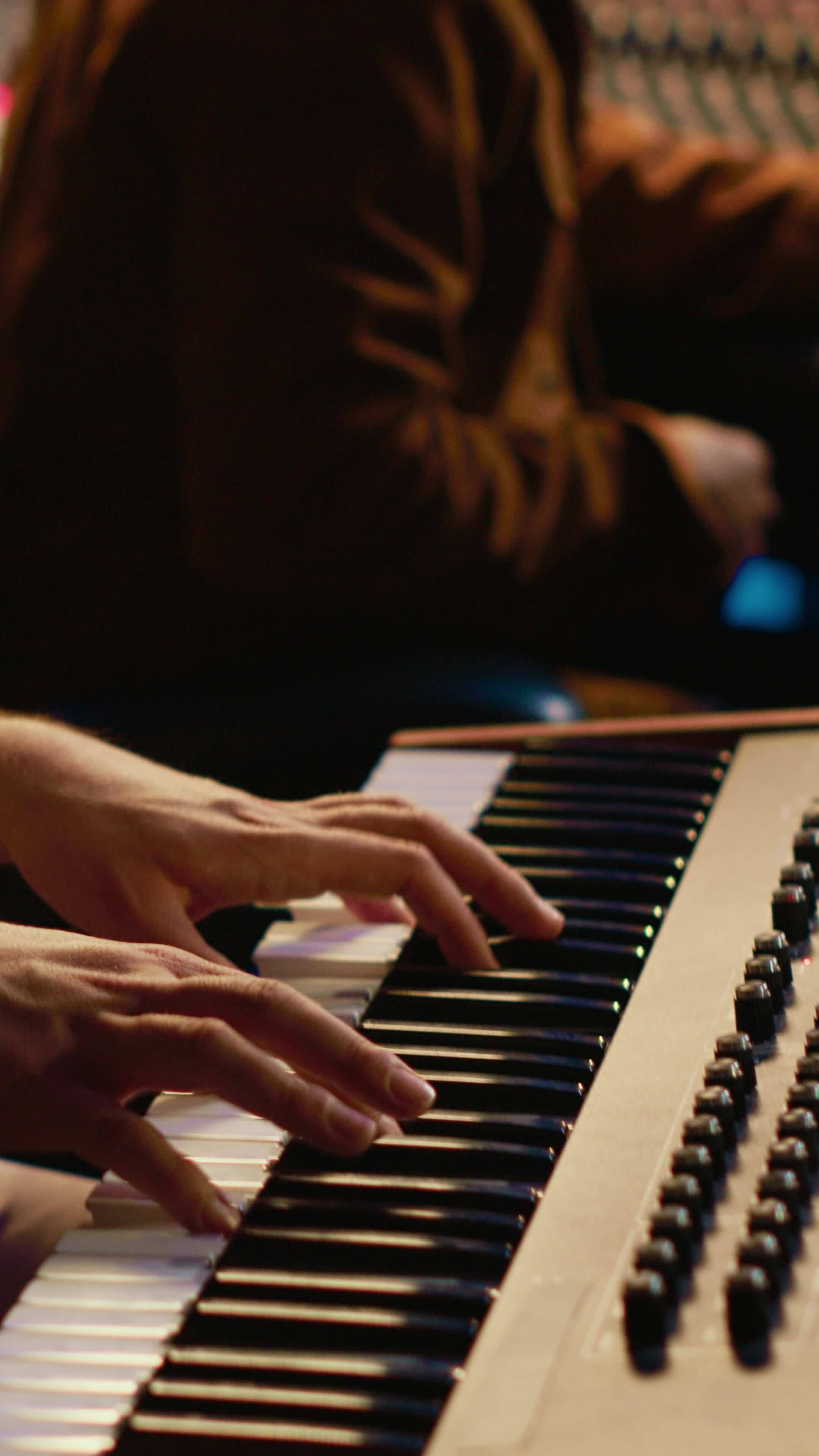 Vertical Musician artist playing midi controller synthesizer in