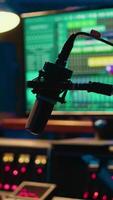 Vertical Empty professional recording studio with audio software on pc and control desk buttons or sliders. Technical equipment used to mix and master tracks, editing in post production. video