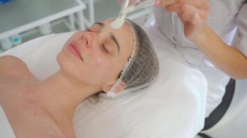 a woman getting a facial massage in a beauty salon video