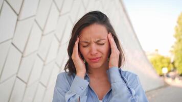 a woman is holding her head in her hands video